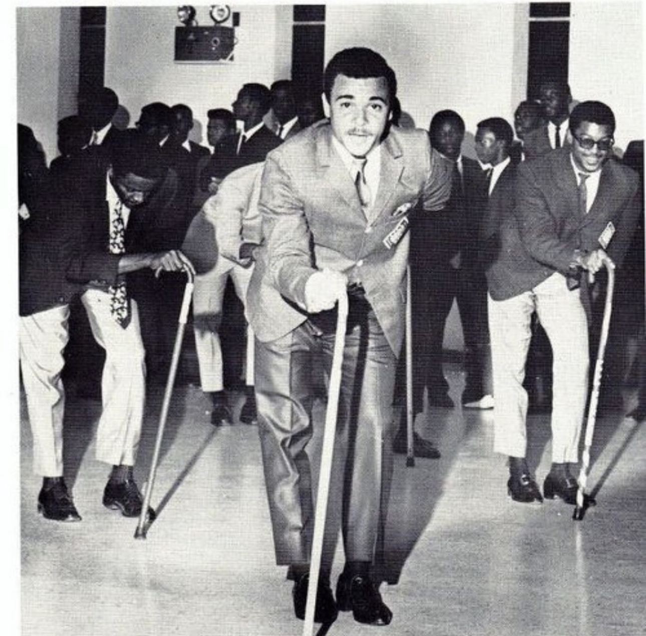 Black and white archival photo of brothers performing with canes at a Kappa Smoker