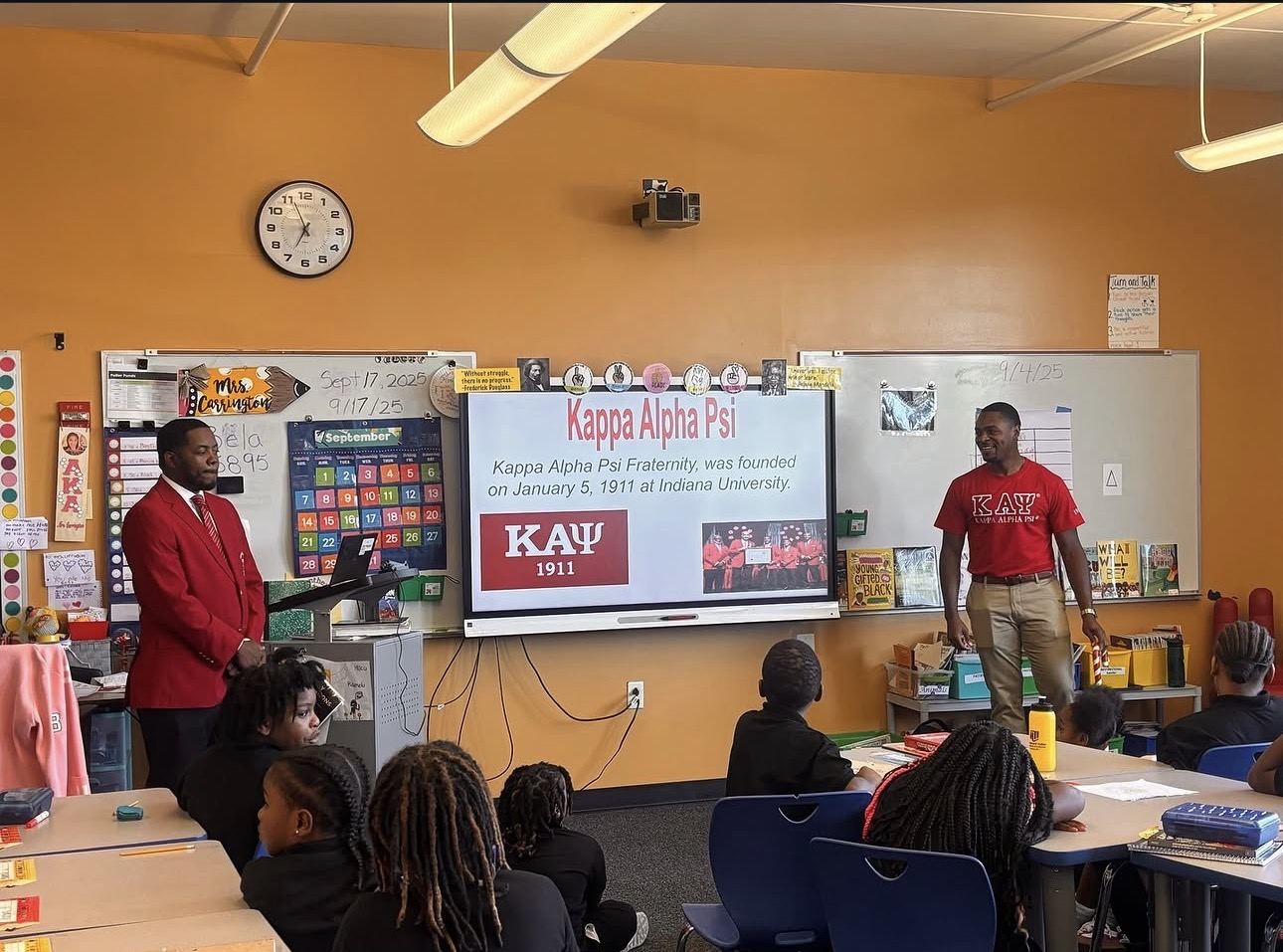 Two brothers presenting the history of Kappa Alpha Psi to a classroom of students