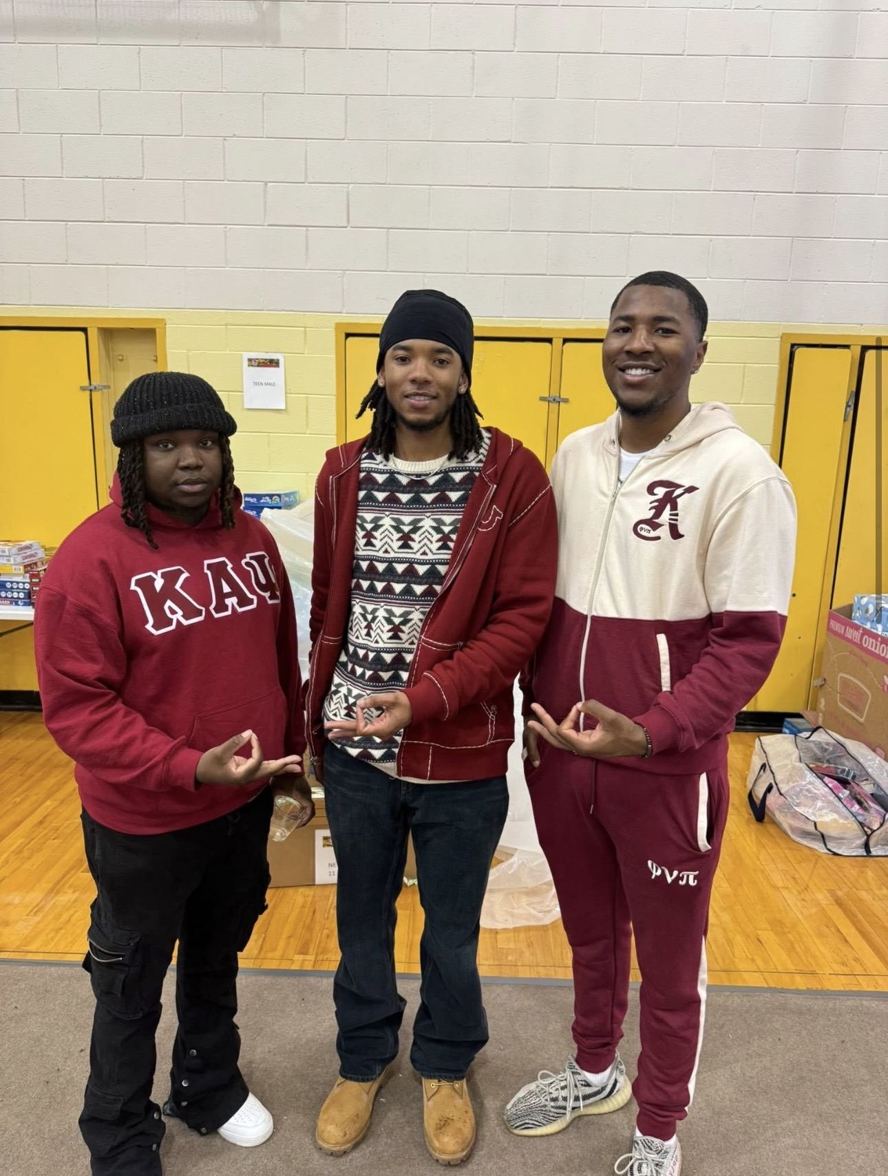 Three brothers volunteering at a community donation drive